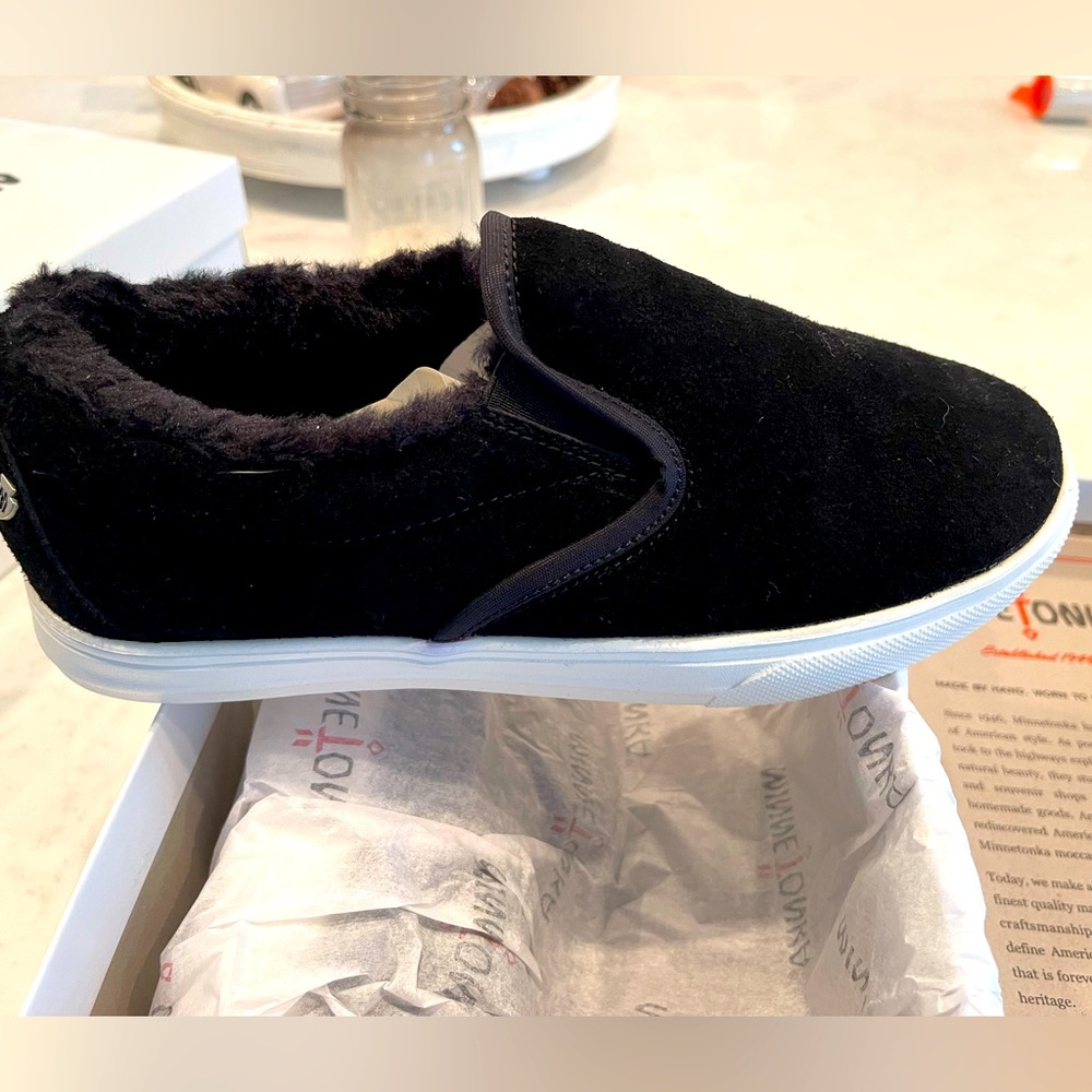 Authentic Minnetonka moccasins.  Black color size 8 never worn. Still in box